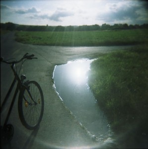 Fisheye portrait of a bike on a field path